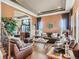 Spacious living room with hardwood floors, a coffered ceiling, and a comfortable seating arrangement, perfect for relaxation at 12745 Uinta St, Brighton, CO 80602