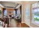 Elegant living room featuring hardwood floors, a coffered ceiling, and a grand staircase, exuding sophistication at 12745 Uinta St, Brighton, CO 80602