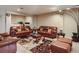 A cozy living room with matching leather furniture and a large decorative rug at 12745 Uinta St, Brighton, CO 80602