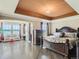 Spacious main bedroom featuring an oversized bed, tray ceiling, large windows, and great views at 12745 Uinta St, Brighton, CO 80602