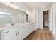 Double vanity bathroom with a large mirror and walk-in shower at 3254 Boral Owl Dr, Brighton, CO 80601