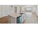 Kitchen island with white cabinets and stainless steel appliances at 3254 Boral Owl Dr, Brighton, CO 80601