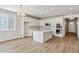 Open concept kitchen with island and white cabinets at 3254 Boral Owl Dr, Brighton, CO 80601