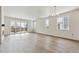 Bright living room with hardwood floors and sliding glass doors leading to a deck at 3254 Boral Owl Dr, Brighton, CO 80601