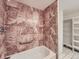 Bathroom with ceramic tile, walk in closet and tub with safety bar at 1250 N Humboldt St # 201, Denver, CO 80218