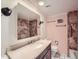 Bathroom featuring a vanity sink, a mirrored medicine cabinet, and a tile shower at 1250 N Humboldt St # 201, Denver, CO 80218