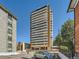 Exterior shot of a modern high-rise building with balconies and well-maintained landscaping at 1250 N Humboldt St # 201, Denver, CO 80218