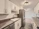 Well-lit kitchen featuring white cabinetry, stainless steel appliances, and updated countertops at 1250 N Humboldt St # 201, Denver, CO 80218