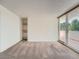 Cozy carpeted room with built-in shelving and a sliding glass door leading to a private balcony at 1250 N Humboldt St # 201, Denver, CO 80218