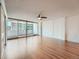 Bright living room with hardwood floors, a ceiling fan, and sliding doors leading to a balcony at 1250 N Humboldt St # 201, Denver, CO 80218