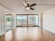 Spacious living room featuring hardwood floors, ceiling fan, and sliding glass doors to a private patio at 1250 N Humboldt St # 201, Denver, CO 80218