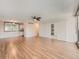 Open living room with hardwood floors, a ceiling fan, and a sliding barn door to adjacent space at 1250 N Humboldt St # 201, Denver, CO 80218