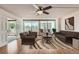 Spacious living room featuring a ceiling fan, wood flooring, and sliding glass doors to a private balcony at 1250 N Humboldt St # 201, Denver, CO 80218
