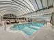 Inviting indoor pool with a vaulted ceiling, surrounded by comfortable seating and sun loungers at 1250 N Humboldt St # 201, Denver, CO 80218