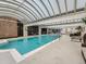 Indoor pool with clear, blue water, surrounded by lounge chairs and a retractable roof for natural light at 1250 N Humboldt St # 201, Denver, CO 80218