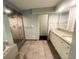 Spacious bathroom featuring a tiled shower, granite countertops, and modern vanity at 7255 E Quincy Ave # 309, Denver, CO 80237