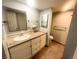 Well-lit bathroom with granite countertop, vanity, and a mirror, offering a clean and modern space at 7255 E Quincy Ave # 309, Denver, CO 80237