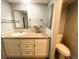 Bathroom with a granite countertop, vanity, and mirror, offering a bright and functional space at 7255 E Quincy Ave # 309, Denver, CO 80237