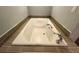 Relax in this white built-in bathtub with tile surround, offering a serene bathing experience at 7255 E Quincy Ave # 309, Denver, CO 80237