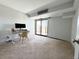 Spacious bedroom with a sliding glass door leading to a balcony, complete with a comfortable workspace at 7255 E Quincy Ave # 309, Denver, CO 80237