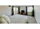 Bright bedroom with plush bedding, a sliding glass door, a window for natural light, and modern decor at 7255 E Quincy Ave # 309, Denver, CO 80237
