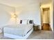 Comfortable bedroom with neutral color scheme, a cozy bed, soft lighting, and doorway to an adjacent room at 7255 E Quincy Ave # 309, Denver, CO 80237