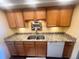 Cozy kitchen featuring granite countertops, ample wooden cabinets, and modern stainless steel appliances, perfect for cooking at 7255 E Quincy Ave # 309, Denver, CO 80237
