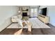 Cozy living room with stone fireplace, comfortable seating, and natural light, complemented by wood floors and modern decor at 7255 E Quincy Ave # 309, Denver, CO 80237