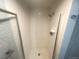 Modern shower stall with white tiled walls and glass door, offering a sleek and clean design at 7255 E Quincy Ave # 309, Denver, CO 80237