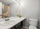 Bathroom with modern sink, mirror, and toilet at 8199 Welby Rd # 1102, Denver, CO 80229