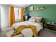 Bedroom features a queen-size bed and yellow decor at 8199 Welby Rd # 1102, Denver, CO 80229