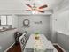 Dining room with a gray table and chairs, a bar cart, and a ceiling fan at 8199 Welby Rd # 1102, Denver, CO 80229