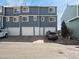 Exterior view of blue townhomes featuring garage parking at 8199 Welby Rd # 1102, Denver, CO 80229