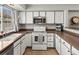 Bright kitchen with white cabinets, stainless steel appliances, and a view of the outdoors at 8199 Welby Rd # 1102, Denver, CO 80229