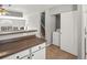 View of the kitchen counter leading to the laundry area with a modern washer and dryer at 8199 Welby Rd # 1102, Denver, CO 80229