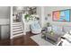 A cozy living room features wood floors, stairs to the kitchen, and stylish decor with ample sunlight at 8199 Welby Rd # 1102, Denver, CO 80229