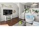 Relaxing living room with dark wood floors, stairs, and large television is perfect for entertaining at 8199 Welby Rd # 1102, Denver, CO 80229