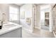 Modern bathroom with double vanity, sleek countertops, tile floors, and walk-in closet at 23731 E 40Th Ave, Aurora, CO 80019