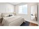 Bright bedroom featuring a large window, hardwood floors, and a stylish full-length mirror at 23731 E 40Th Ave, Aurora, CO 80019