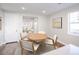 Dining room with hardwood floors, modern chairs, a round table, and natural light at 23731 E 40Th Ave, Aurora, CO 80019