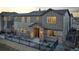 Beautiful two-story home featuring a stone entryway, black metal fence, and neutral-colored siding at sunset at 23731 E 40Th Ave, Aurora, CO 80019