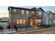 Attractive two-story home featuring stone accents and a cozy front yard with a black fence at 23731 E 40Th Ave, Aurora, CO 80019