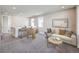 Cozy and neutral loft area with sofa, desk, chair, decorative pillows, and natural light at 23731 E 40Th Ave, Aurora, CO 80019