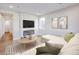 Inviting living room with a large sofa, modern fireplace, and contemporary decor at 23731 E 40Th Ave, Aurora, CO 80019