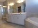 Elegant bathroom with double vanity, soaking tub, and shower at 1153 Elbridge Dr, Elizabeth, CO 80107
