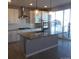 Well-lit kitchen with a stainless steel hood, appliances, gray island, and a large window at 1153 Elbridge Dr, Elizabeth, CO 80107