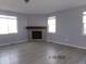Bright living room features a cozy fireplace, hard surface floors, and large windows for plenty of natural light at 1153 Elbridge Dr, Elizabeth, CO 80107