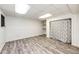 Finished basement with gray wood floors, drop ceiling, and storage space at 4274 S Fundy Way, Aurora, CO 80013