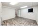 Spacious basement featuring gray wood floors, white walls, and natural light at 4274 S Fundy Way, Aurora, CO 80013