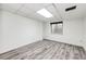 Finished basement with wood-style flooring, drop ceiling with bright lighting, and a small window at 4274 S Fundy Way, Aurora, CO 80013